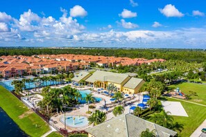 A resort with a swimming pool, sun loungers, and a large building with a green roof. - Flash 20 Off Spetacular Townhome With Private Pool Close to Disney 8919pp (Kissimmee)