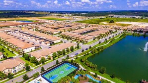 An aerial view of a residential area with multiple apartment buildings, a basketball court, and a swimming pool. - Flash 20 Off Amazing New Townhome With Pvt Pool and Access to Clubhouse Close to Disney (Kissimmee)