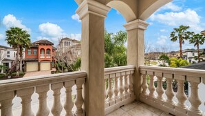 A balcony with a balustrade overlooking a residential area with palm trees and houses. - Rc164p Fairway Fun Castle (Kissimmee)