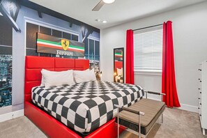A bedroom with a red headboard, a checkered bedspread, a bench at the foot of the bed, a cityscape view through a window, and a Ferrari logo on the wall. - Rc104p Fairway Bliss (Kissimmee)