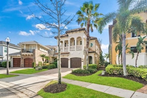 A residential building with a two-story structure, a balcony, and a garage. - Rd989m Fairway Haven (Kissimmee)