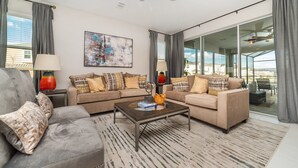 Una sala de estar moderna con un conjunto de sofá, una mesa de centro y un amplio ventanal con vistas a la ciudad.
