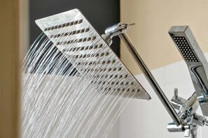 A showerhead with multiple nozzles and a separate handheld showerhead. - Tuscan Hills Home Private Pool, Game Room& Near Disney (Davenport)