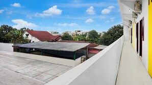 A building with a covered outdoor area, a tiled floor, and a clear sky. - Hotel O near Ring Road City Walks (Medan)