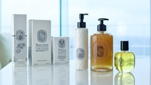 A selection of skincare products on a reflective surface.