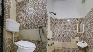 A bathroom with a toilet, a shower, and a sink. - Roomshala Hotel Iconic Near Karol Bagh (New Delhi)