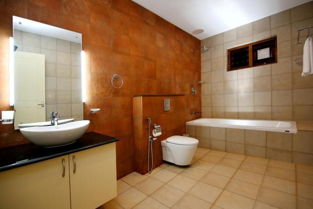 A bathroom with a sink, toilet, and bathtub.