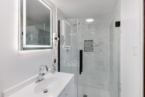 Shower, hair dryer, towels, toilet paper