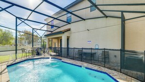 An indoor swimming pool with a glass ceiling, surrounded by a covered patio area with seating and a view of the outside. - Golf, Dine & Unwind Poolside! Haines City Getaway (Haines City)