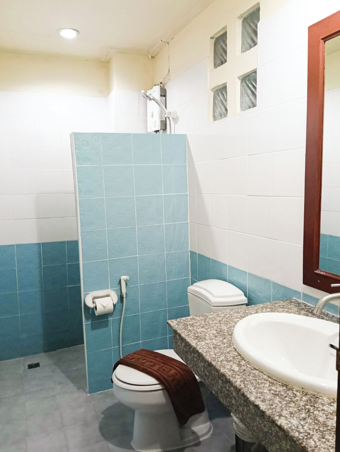 Ein Badezimmer mit Dusche, Toilette und Waschbecken.