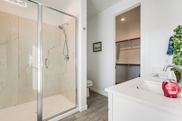 A modern bathroom with a glass-enclosed shower, a white sink with a plant, and a toilet. - Snowbird Escape w/ Pool, 7 Mi to Dtwn Gilbert! (Gilbert)