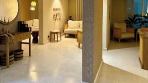 A spacious living area with a sofa, a coffee table, and a lamp. There is a wooden desk with a chair and a mirror on the wall. - Holiday and rest apartment near the sea (Cartagena de Indias)