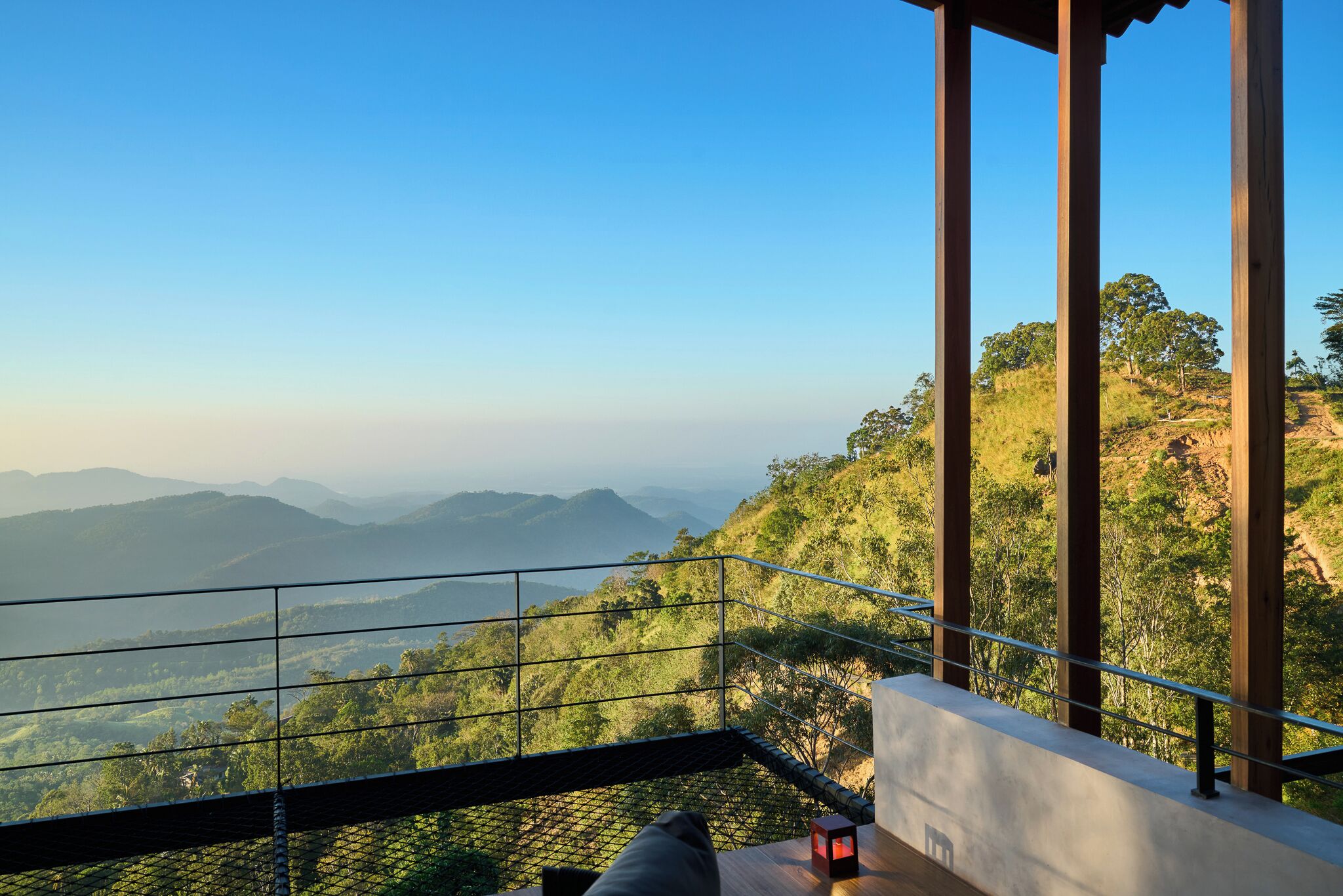 A balcony with a view of a mountainous landscape.