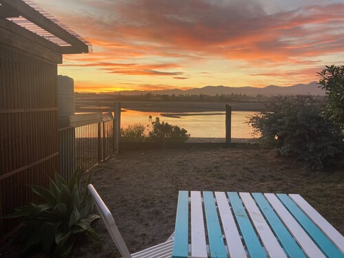 Wake up to bird song and calming estuary views on the beautiful Kina Peninsula