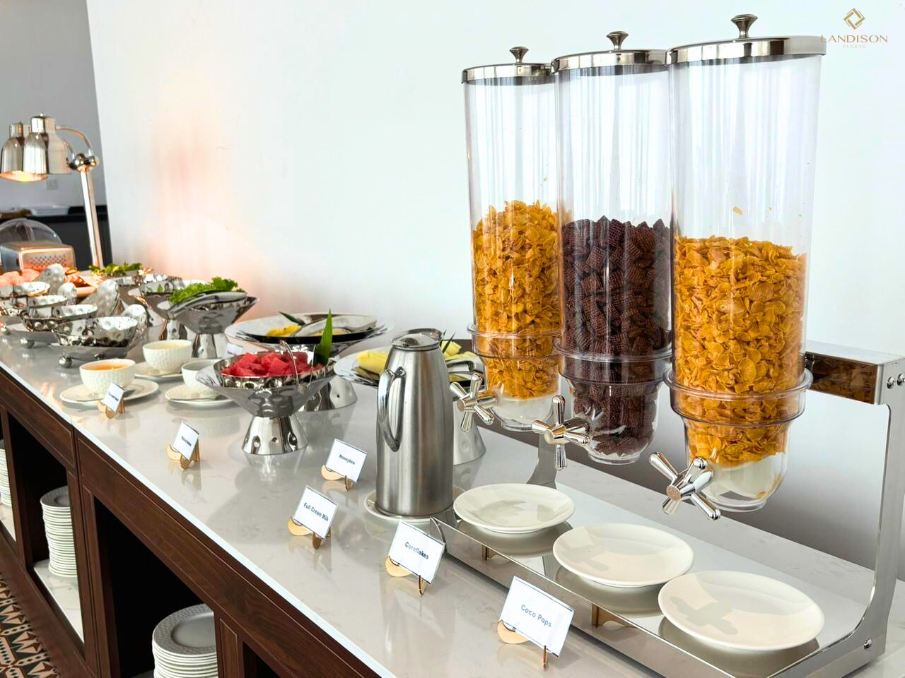 A buffet setup with various food items and a coffee station.