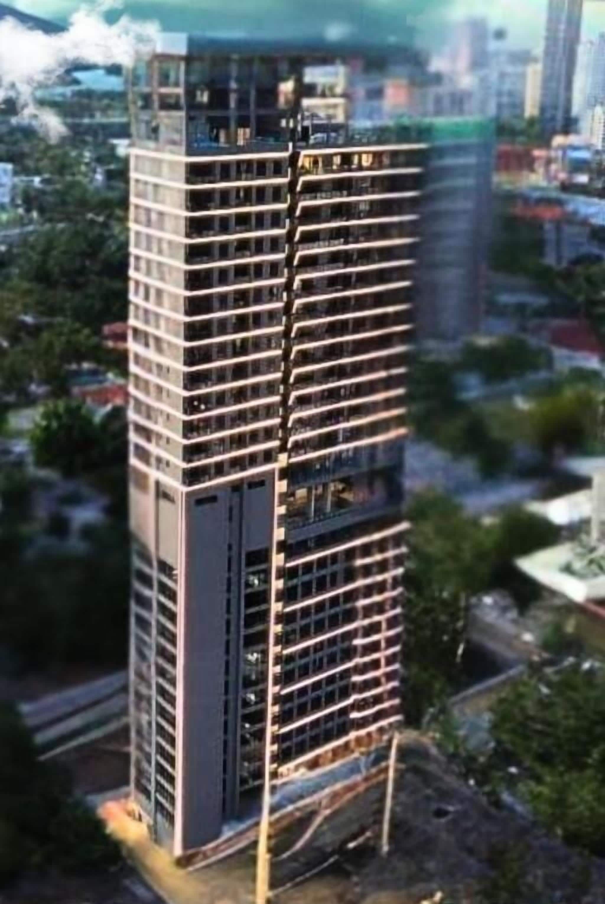 A high-rise building with multiple floors, large windows, and a modern architectural design.