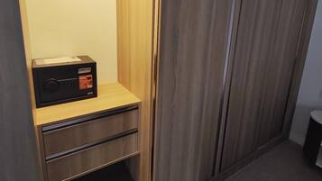 A walk-in closet with wooden shelving, a built-in radio, and a mirror.