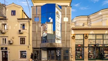 A building with a modern facade, large windows, and a visible storefront with a sign.
