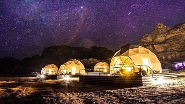 A series of dome-shaped accommodations under a starry night sky. - Room-rum Magic Luxury Camp (Wadi Rum)
