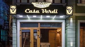 A hotel entrance with a sign reading "Casa Verdi" and a logo on the sides. - Boutique Hotel Casa Verdi (Veliko Tarnovo)
