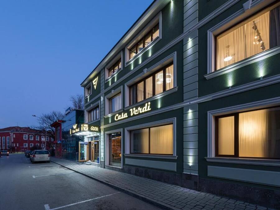 A multi-story building with a sign reading "Casa Verde".