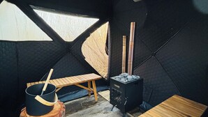 A tent interior with a table, a stove, and a pot. - Nordic Experience: Sauna & Cold Bath in the Camargue (Arles)