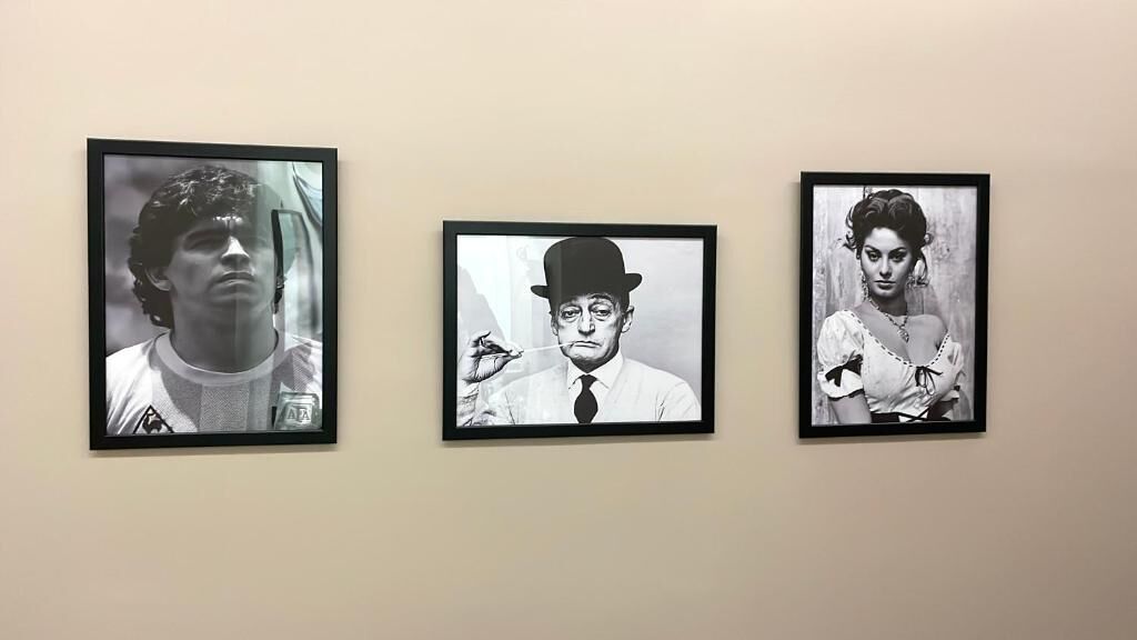 Three framed black and white photographs on a wall.