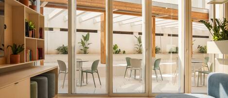 A modern interior with a sliding glass door leading to an outdoor patio area.