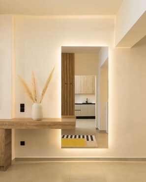 A modern kitchen with wooden cabinets and a central island. - Ivory by halu! - Elegant 2BD apt with sea view (Thessaloniki)