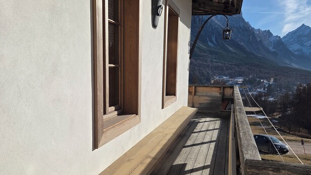 A wooden deck with a view of mountains.