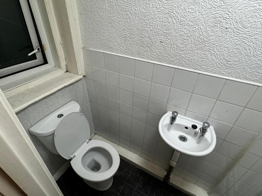 A small bathroom with a toilet and a sink.