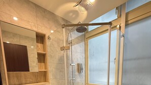 A modern bathroom with a glass-enclosed shower, a vanity with a sink, and a toilet. - 35APT- Self Check In (Taipei)