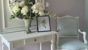 A white vanity with a mirror, a vase with white flowers, and a framed picture of a bird. -  BEAUTIFUL 4 BED FAMILY GITE WITH POOL-CHARENTE MARITIME. SLEEPS 10 (Mérignac)