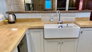 A kitchen with a wooden countertop, a sink, and tiled flooring. -  BEAUTIFUL 4 BED FAMILY GITE WITH POOL-CHARENTE MARITIME. SLEEPS 10 (Mérignac)