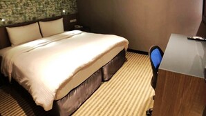 A hotel room with a large bed, a desk, and a telephone. - 128 INN- Self Check In (Taipei)