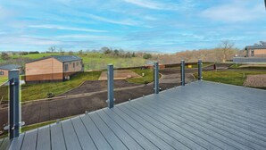A modern building with a flat roof, surrounded by a well-maintained lawn and a clear sky.