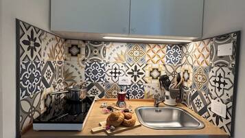 Fridge, stovetop, coffee/tea maker, cookware/dishes/utensils