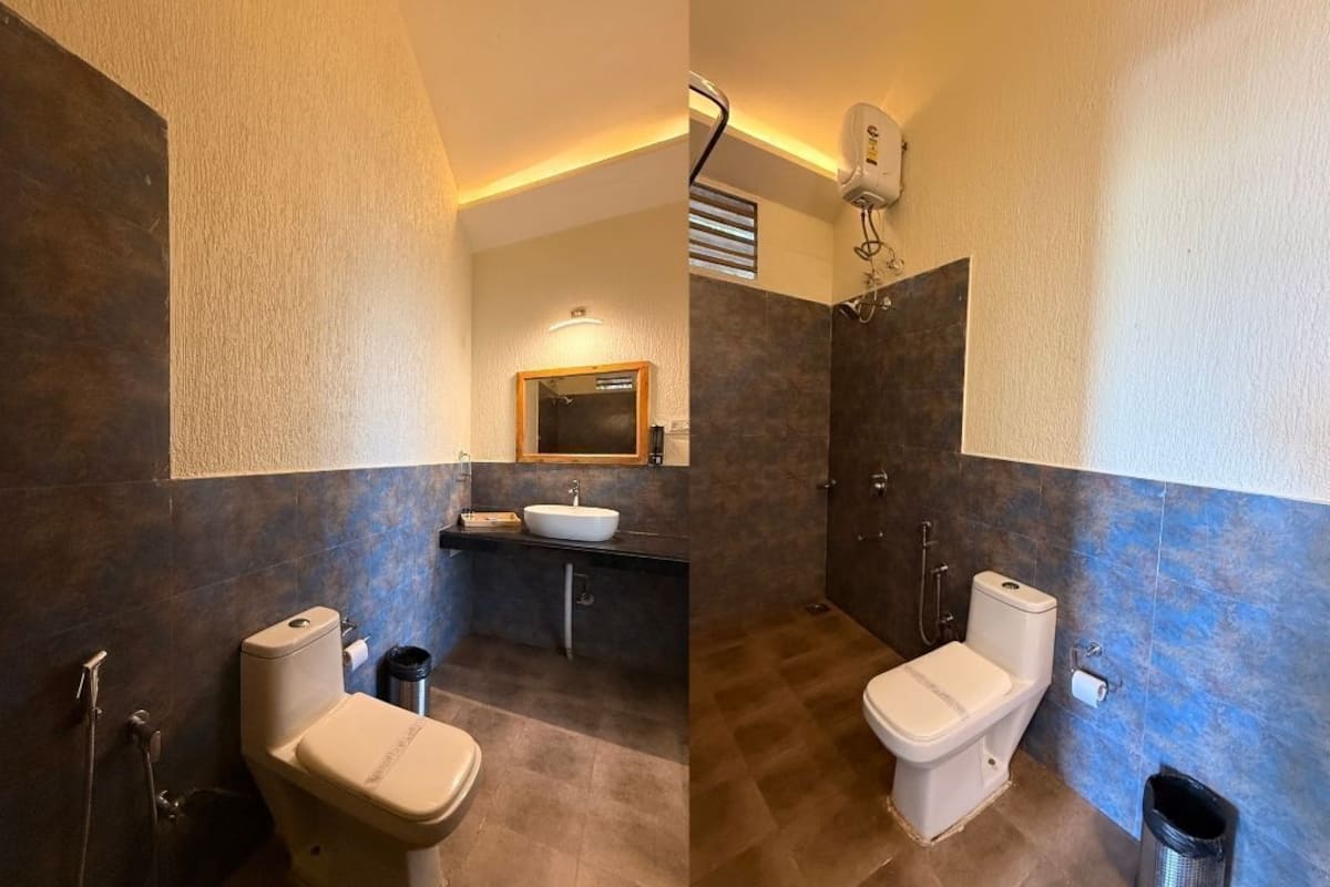 A bathroom with a toilet, bidet, sink, and shower.