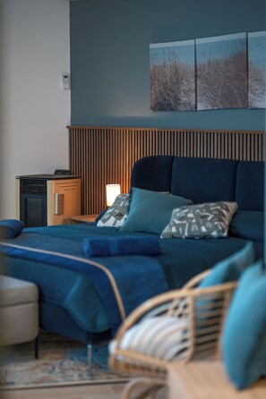 A bedroom with a bed, bedside table, lamp, and a wall-mounted heater. - Exclusive detached villa with a heated outdoor pool and spa (Sicilia)