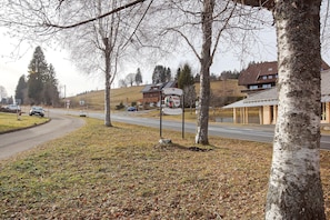 A hotel sign with a restaurant and a road with cars. - Hotel Bären - Three-Star: Double Room 2 / Breakfast Included / 2 Guests / WiFi (Bernau im Schwarzwald)