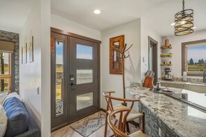 A modern kitchen with a marble countertop, a built-in oven, and a hanging light fixture. - Lakefront Pagosa Springs condo with mountain views, a private deck, grill, and remodeled interiors; three bedrooms and 2.5 baths sleep up to 5 guests. (Pagosa Springs, CO)