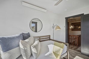 A bedroom with a bed, pillows, a bedside lamp, a mirror, and a view of a dining area. - Lakefront Pagosa Springs condo with mountain views, a private deck, grill, and remodeled interiors; three bedrooms and 2.5 baths sleep up to 5 guests. (Pagosa Springs, CO)