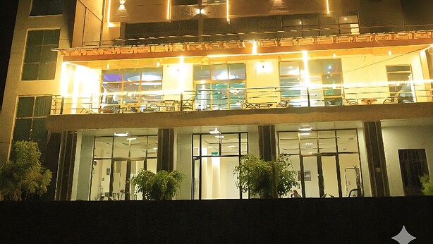 A hotel with a modern facade, multiple floors, and illuminated signage reading "YEMATA-HOTEL". - Yemata Hotel (Gondar)