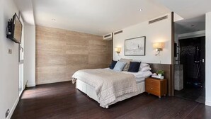 A modern bedroom with a large bed, a nightstand, a wall-mounted light, and a framed picture. - Modern Villa Biot, Entire home in Biot, France (Biot)
