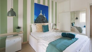 A bedroom with a bed, a nightstand, a dresser, a mirror, and a painting on the wall. - Beautiful private villa for 12 guests with WIFI, private pool, A/C and TV, close to Ostuni (San Vito Dei Normanni)