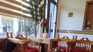 A room with wooden furniture, including two chairs and a table, and a patterned carpet. - Hotel dar farhat (Tunis)