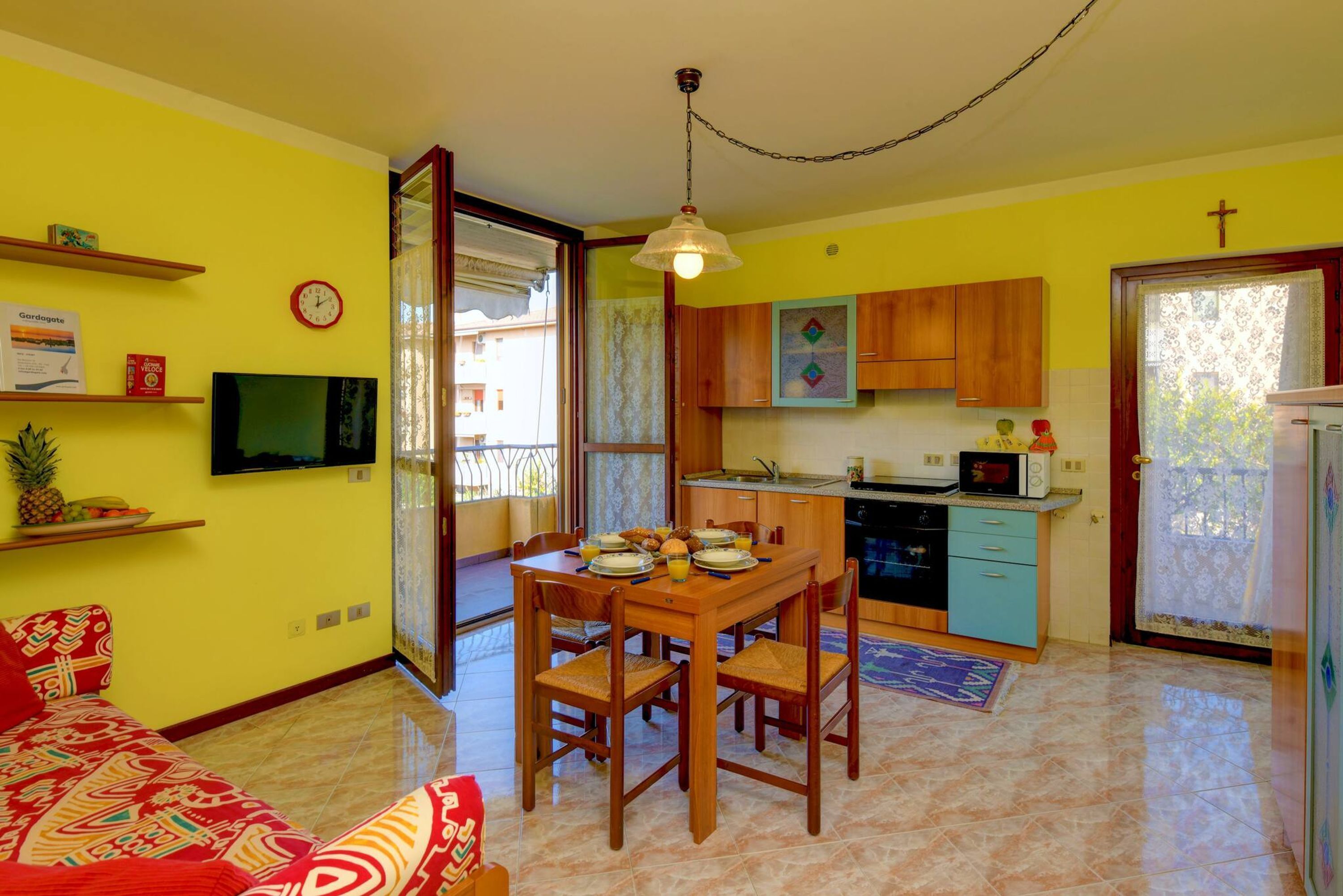 A compact living space with a dining area, kitchen, and a sofa.