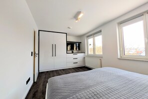 Makuuhuoneessa on suuri sänky, vaatekaappi, ikkuna ja kattovalaisin.