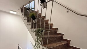 A modern staircase with metal railings and potted plants. - Two-bedroom House Lara Denona (Novalja)