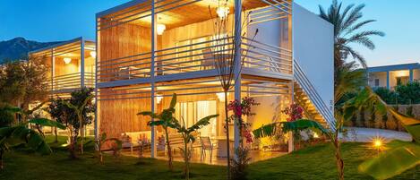 A modern multi-story building with large glass windows and a wooden interior.